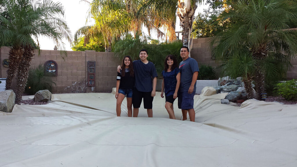 Arizona family standing on Solar Safe Pool Cover demonstrating safety and durability