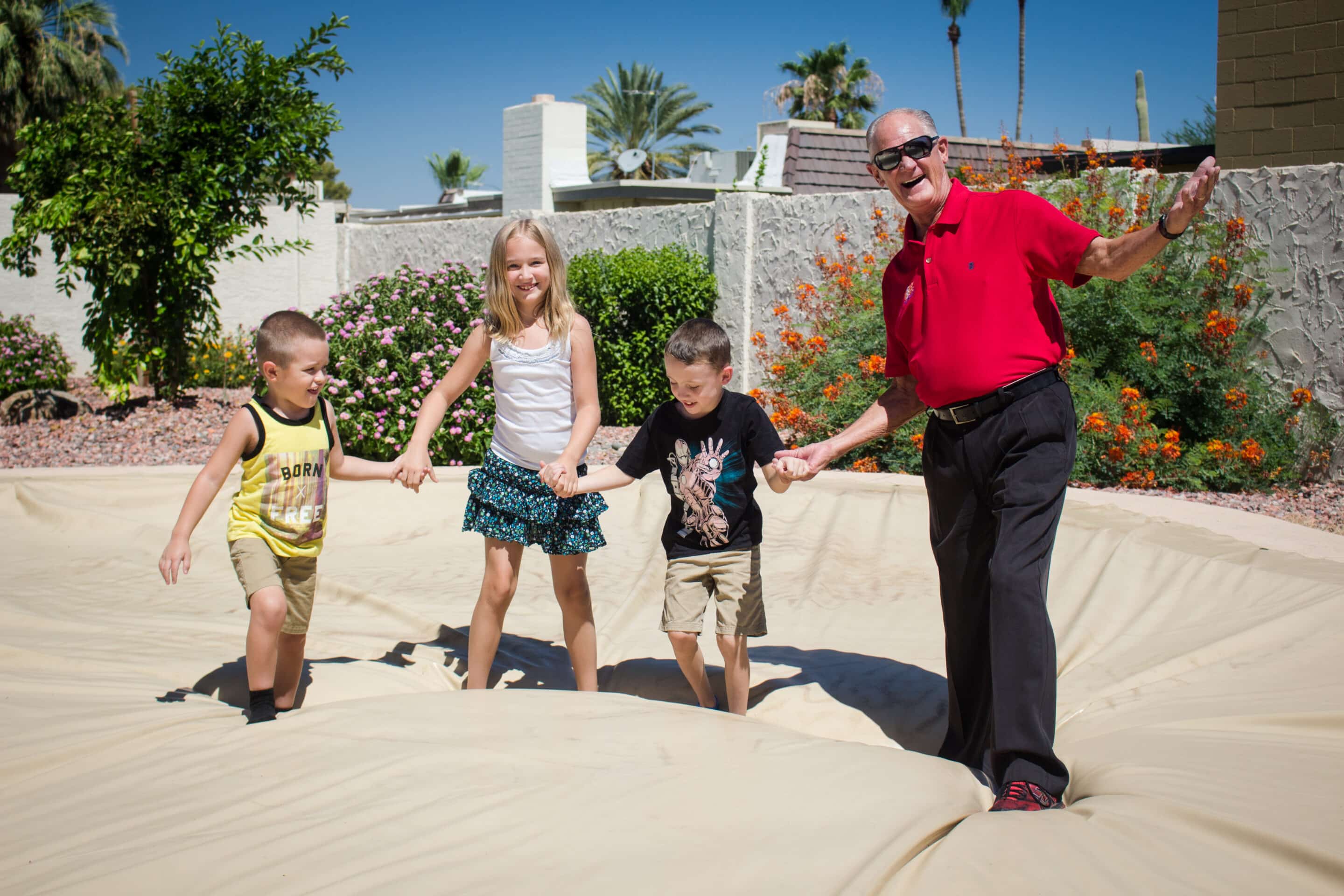 A person standing on an Arizona pool sealed under a PowerLock solar safety cover
